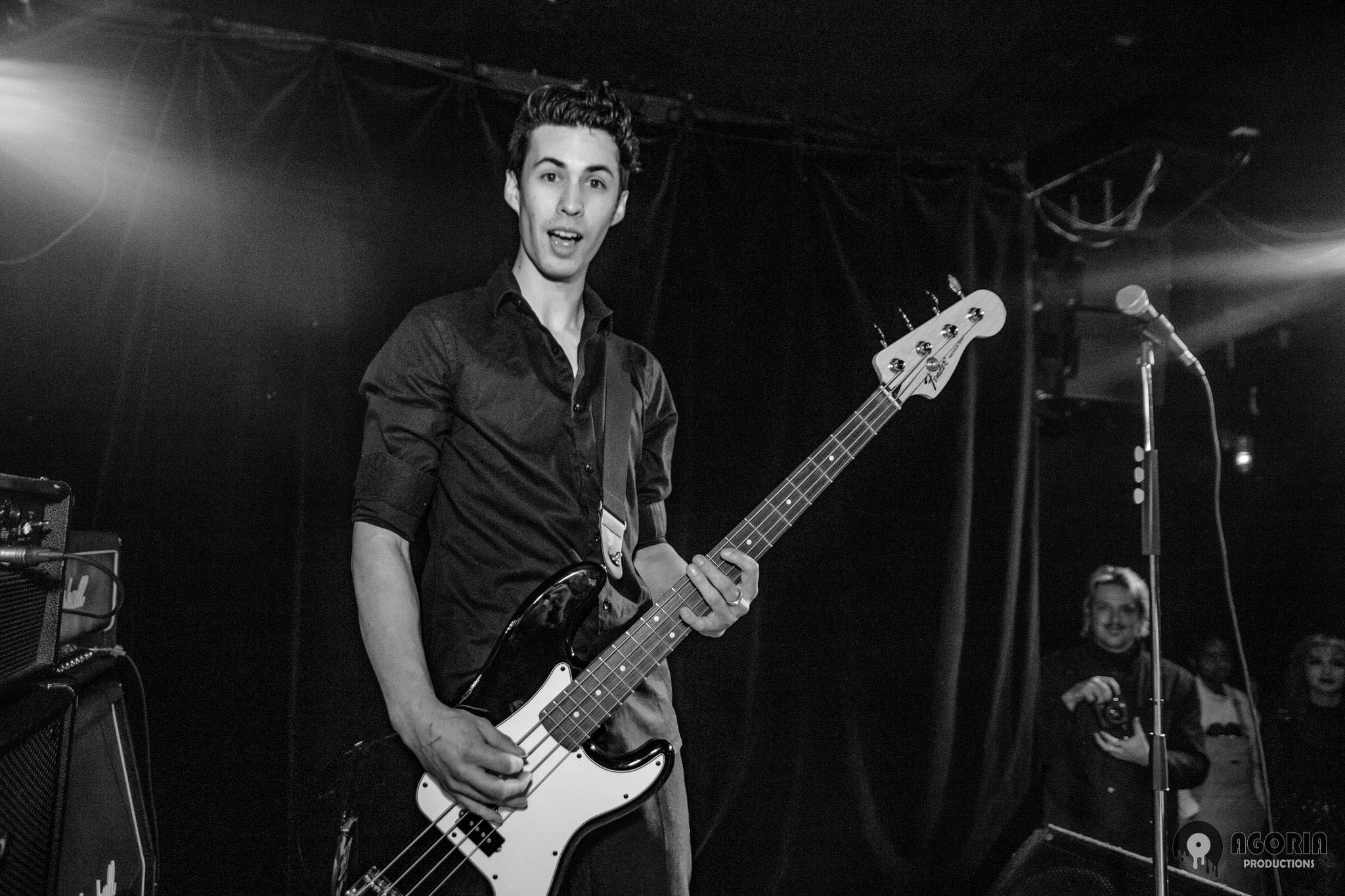 Tyler Twigger playing bass with fluffio & the rpc live in toronto at the baby g smiling at camera black and white