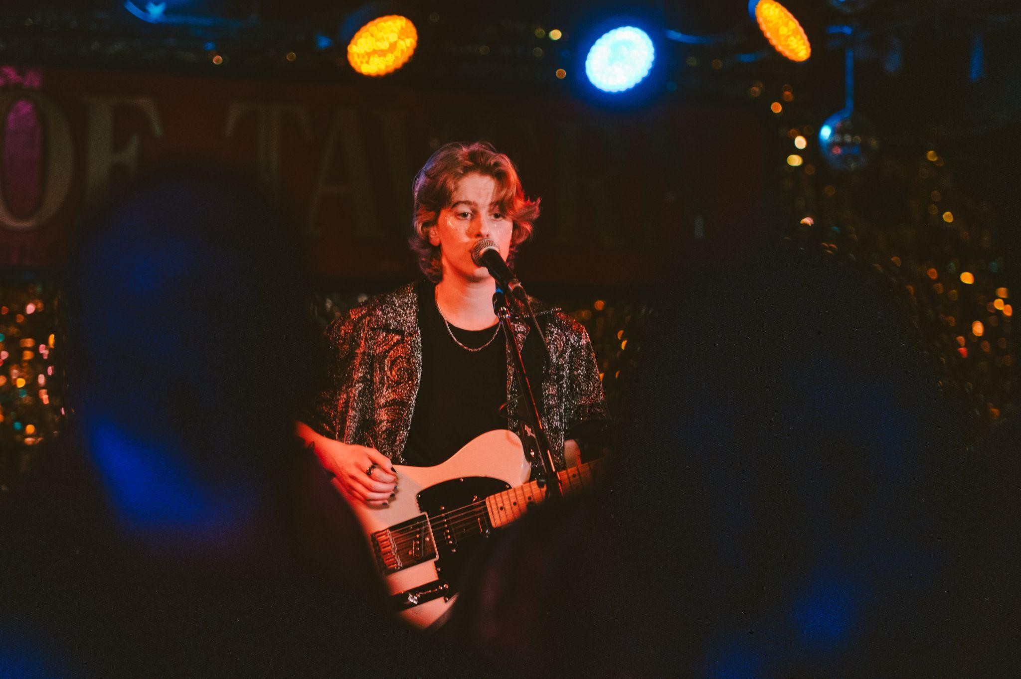 On-stage, Emma Beckett plays guitar for the majority of their set. However, they were brought up with classical piano training, and only began writing their own songs when home alone-, after stealing their brother’s ukulele. Taken By Janine Van Oostrom / @janine.v.photography