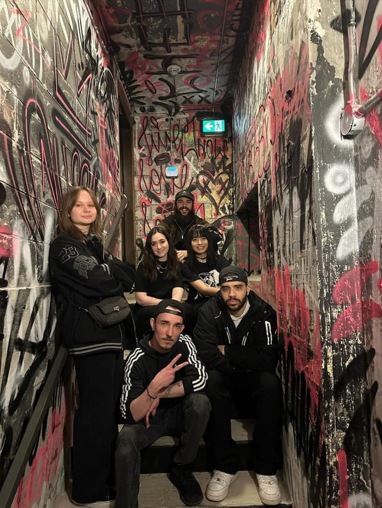 Six people posing in a staircase